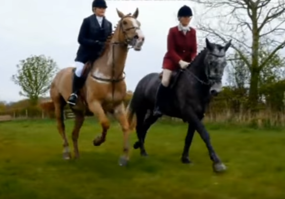 Katie (left) riding her horse in the hunt. 