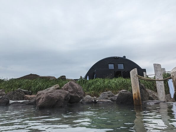 view from the pool towards the bathhouse at Hvammsvik