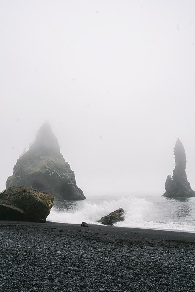 view of the two trolls at the Black Sand Beach Iceland