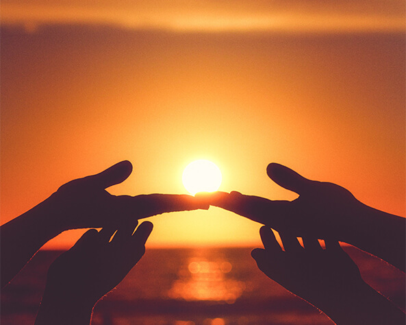 hands gesturing towards the sun