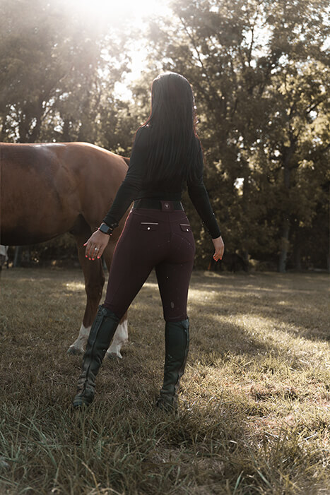horse and model in field with sunlight coming through trees