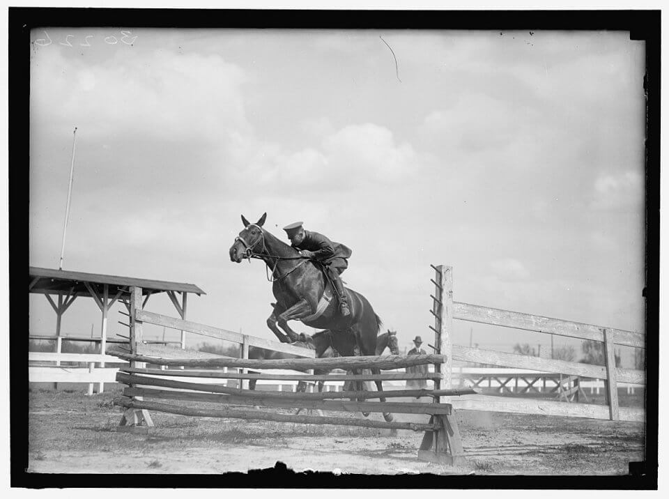 old photograph of military style riding at a horse show
