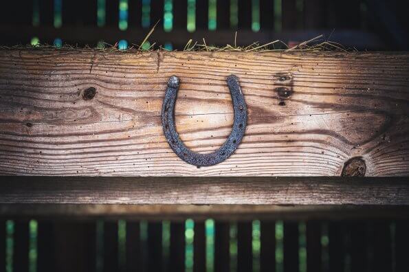 horseshoe nailed to a beam in a barn