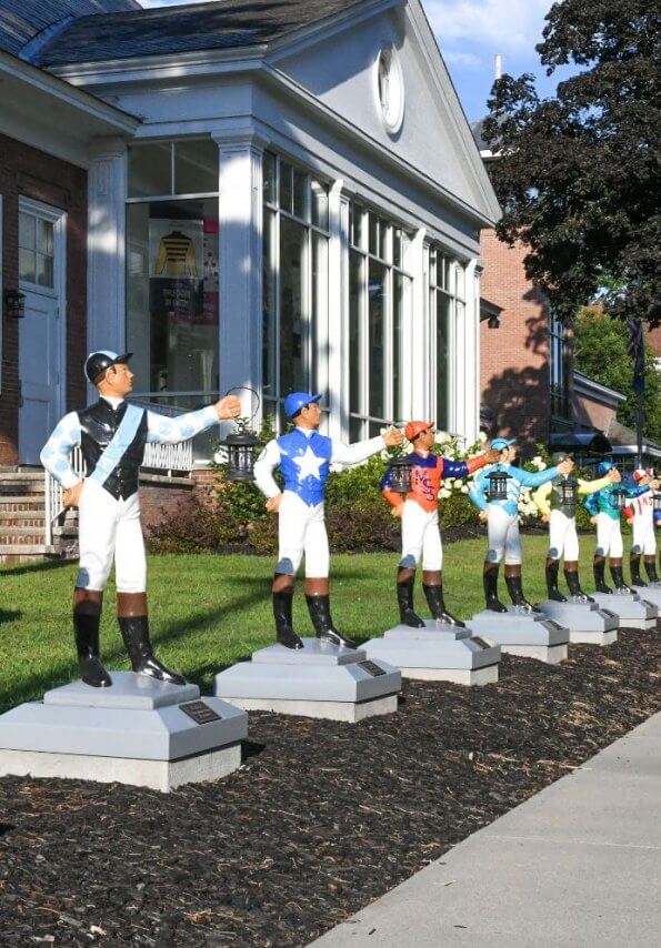 jockey statues lined up outside the Museum of Racing and Hall of Fame