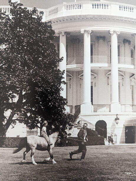 Caroline Kennedy being led by a secret service agent at the White House