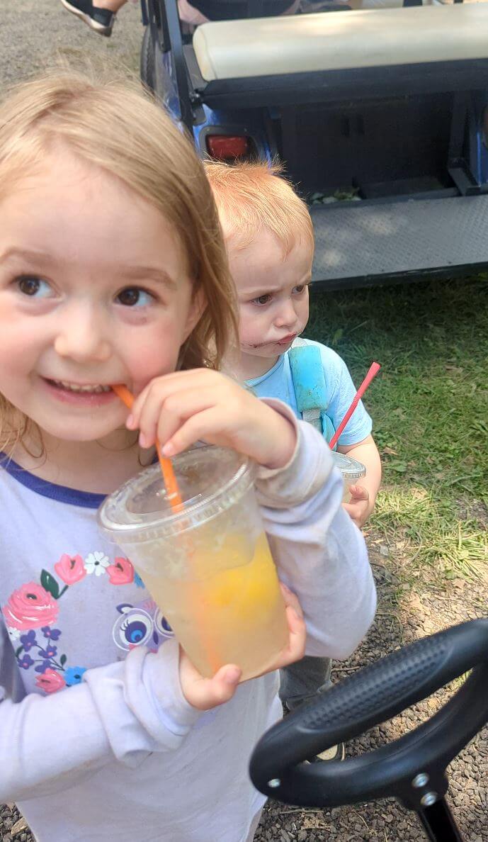 kids drinking lemonade at a horse show
