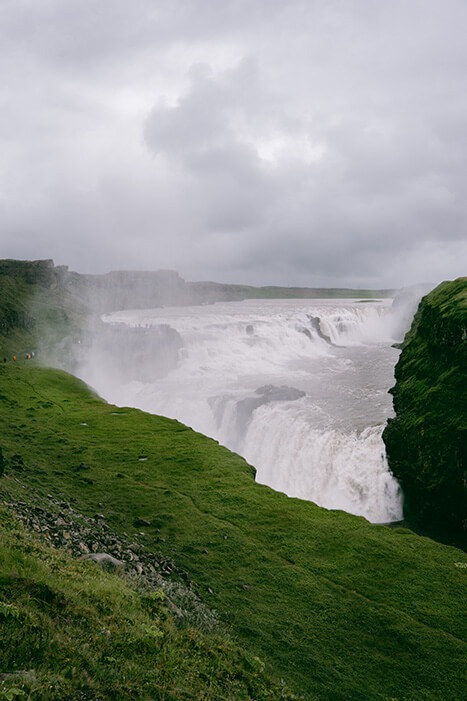 view of the double waterfall Gullfoss in Iceland green grass