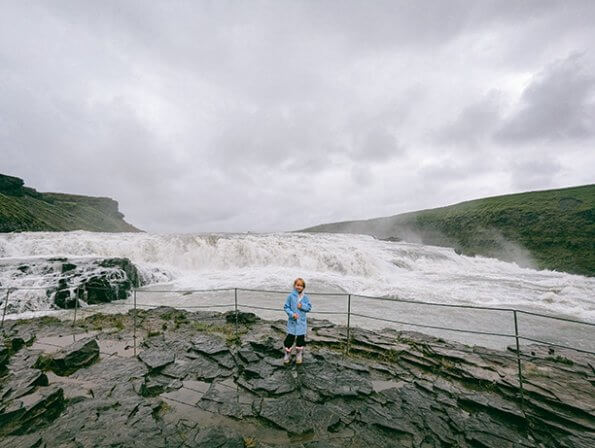 standing in front of top tier of gullfoss waterfall iceland