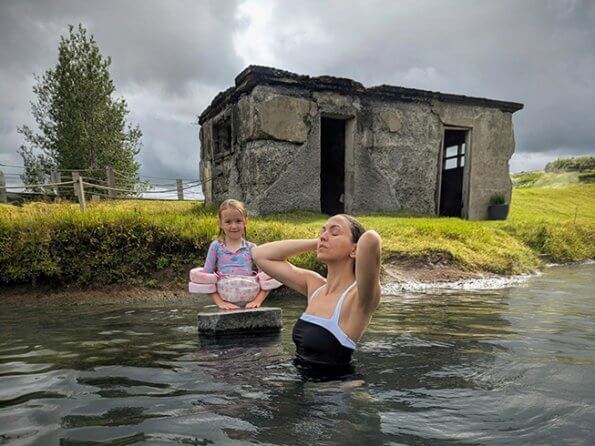 view of woman and child in secret lagoon in Iceland