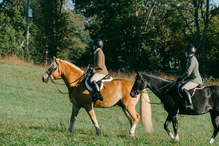 two riders on their horses for a foxhunt